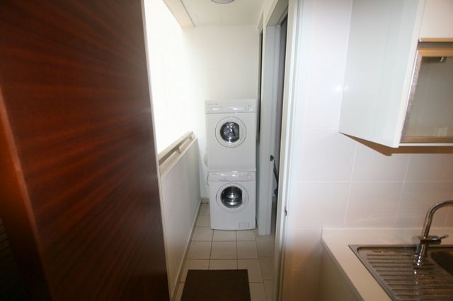 Utility area with washing machine and sink